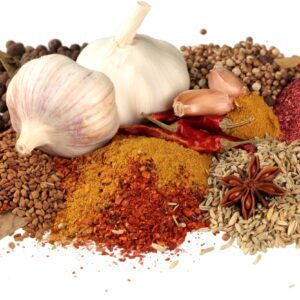 A pile of spices and garlic on top of each other.