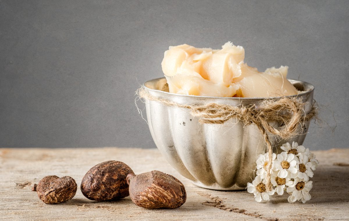 A bowl of nuts and some other food on the table.