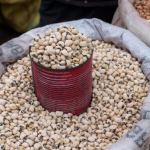 A red can sitting on top of some beans.