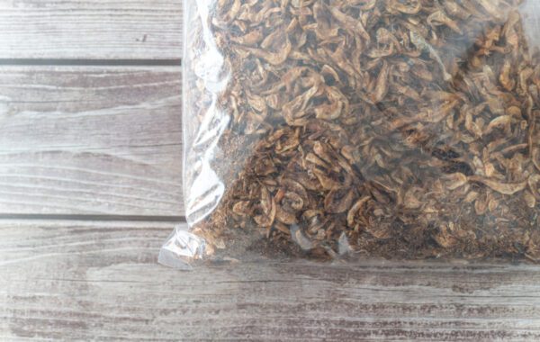 A bag of dried food on top of a wooden table.