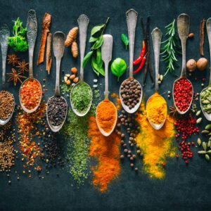 A table topped with lots of spoons filled with different types of food.