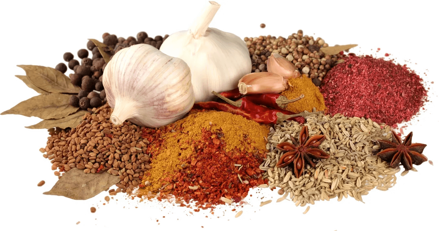 A pile of spices and garlic on top of a table.